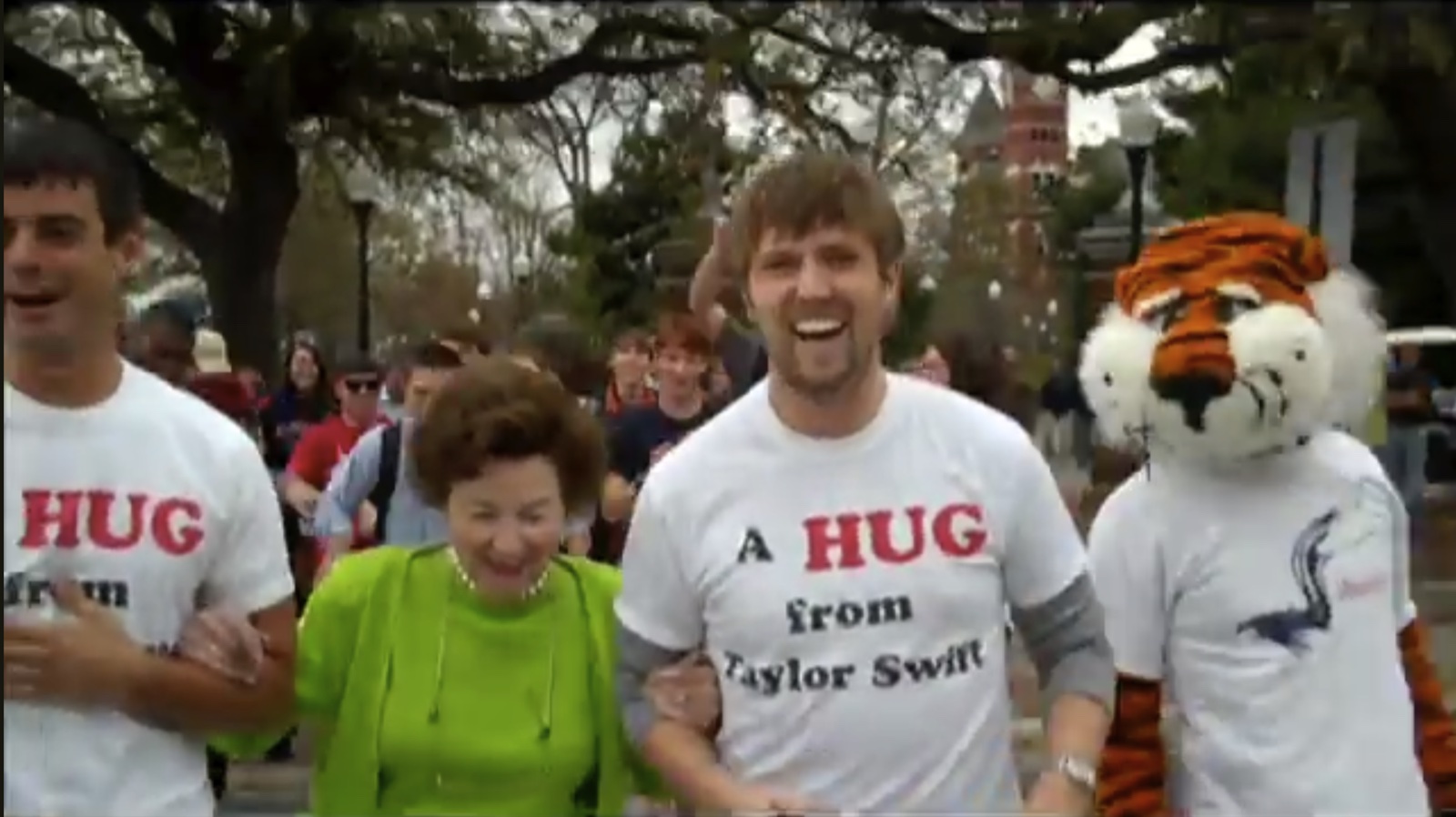 Michael and Ryan in A Hug from Taylor Swift shirts with a crowd and the Auburn mascot